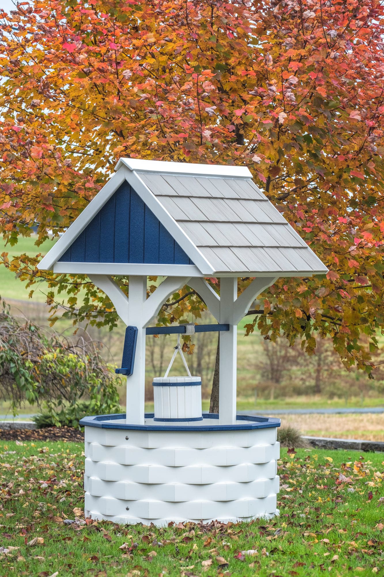 Amish handcrafted poly wishing well in white and bright blue with poly shake roof.